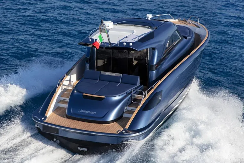  Yacht Photos Pics 2026 Solaris Power 48 Coupe yacht cruising on open sea, rear view.