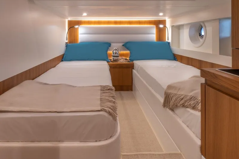  Yacht Photos Pics Luxurious cabin interior of 2026 Solaris Power 48 Coupe with twin beds and modern decor.