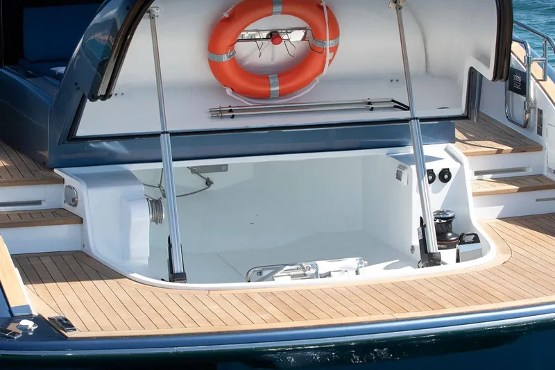  Yacht Photos Pics 2026 Solaris Power 48 Coupe yacht with open storage compartment and life preserver.