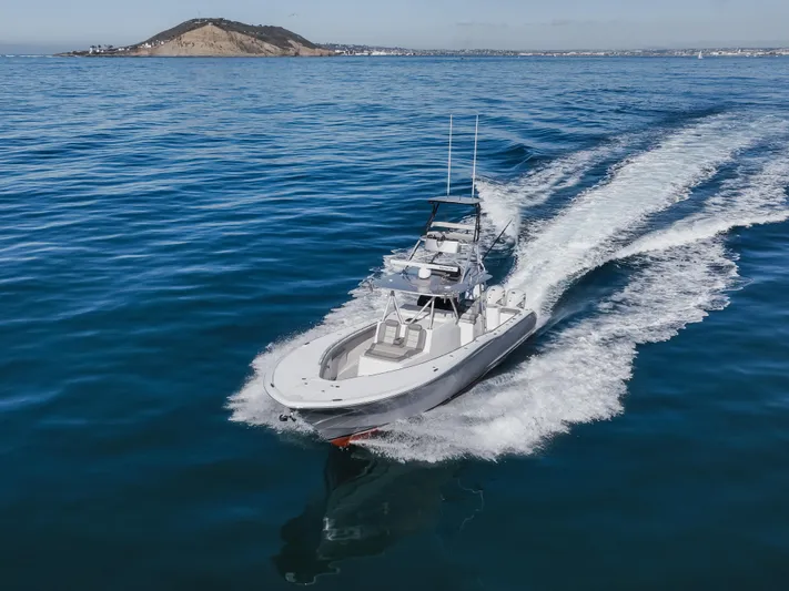Steam N Demon Yacht Photos Pics 2019 Buddy Davis 42 CC cruising on open water near a distant island.
