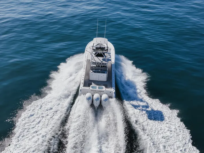 Steam N Demon Yacht Photos Pics 2019 Buddy Davis 42 CC boat cruising on open water, aerial view.