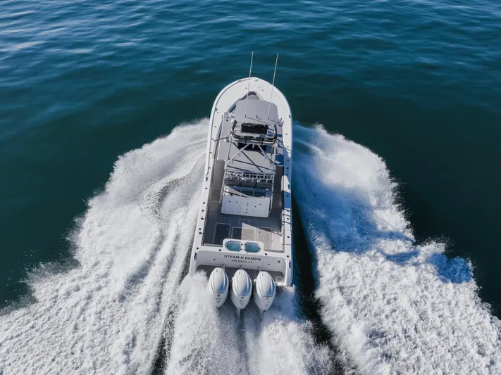 Steam N Demon Yacht Photos Pics 2019 Buddy Davis 42 CC boat cruising on open water, aerial view.