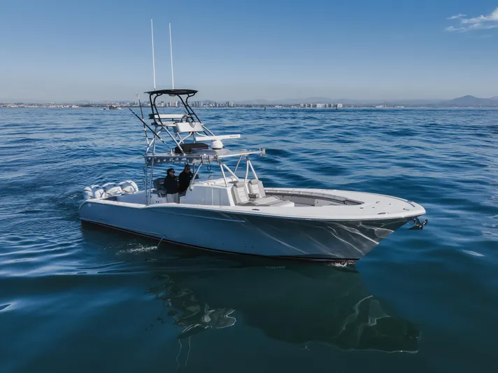 Steam N Demon Yacht Photos Pics 2019 Buddy Davis 42 CC boat cruising on open water under clear blue skies.