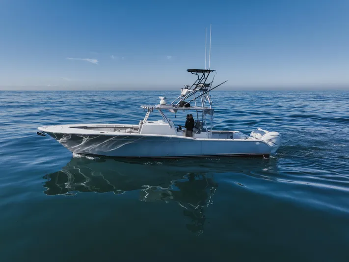 Steam N Demon Yacht Photos Pics 2019 Buddy Davis 42 CC boat on calm ocean waters under clear blue sky.