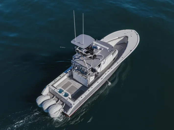 Steam N Demon Yacht Photos Pics 2019 Buddy Davis 42 CC boat cruising on open water, aerial view.