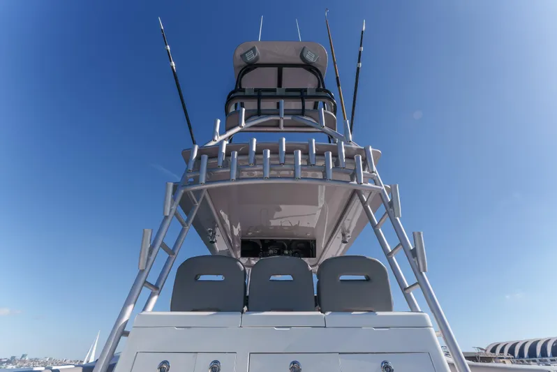 Steam N Demon Yacht Photos Pics 2019 Buddy Davis 42 CC boat with fishing rods and tower against clear blue sky.