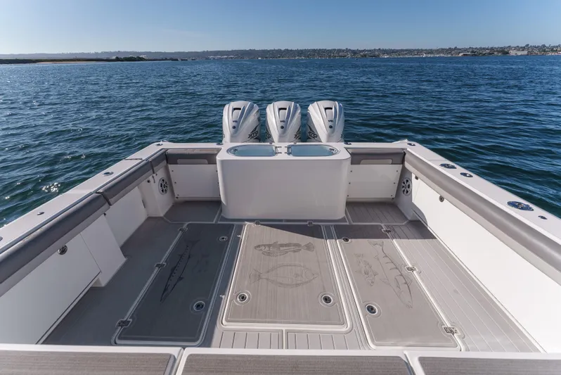 Steam N Demon Yacht Photos Pics 2019 Buddy Davis 42 CC boat deck with triple outboard engines on open water.