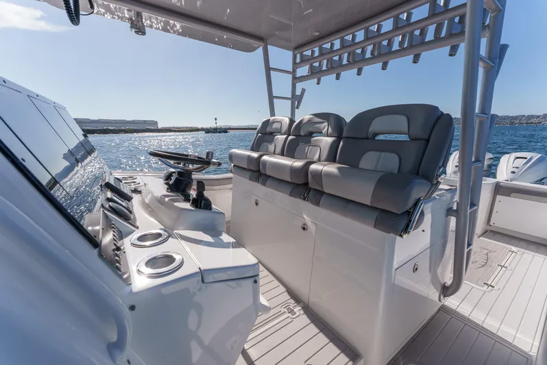 Steam N Demon Yacht Photos Pics 2019 Buddy Davis 42 CC boat interior with helm and seating, on open water.