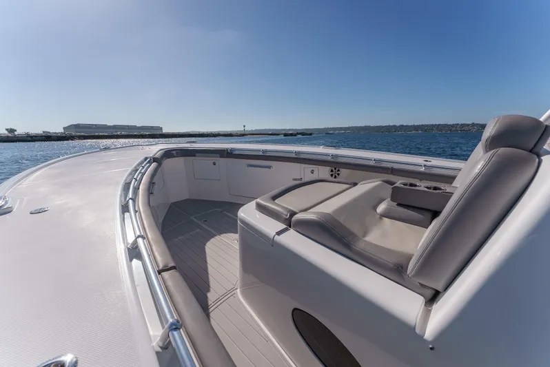 Steam N Demon Yacht Photos Pics 2019 Buddy Davis 42 CC boat deck with seating, overlooking calm waters and clear blue sky.