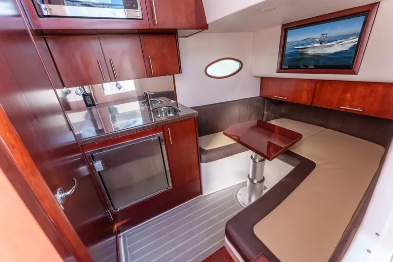 Steam N Demon Yacht Photos Pics Luxurious interior of 2019 Buddy Davis 42 CC boat with kitchenette and seating area.