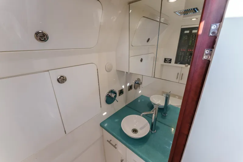 Steam N Demon Yacht Photos Pics Luxurious bathroom in 2019 Buddy Davis 42 CC yacht with modern fixtures and sleek design.