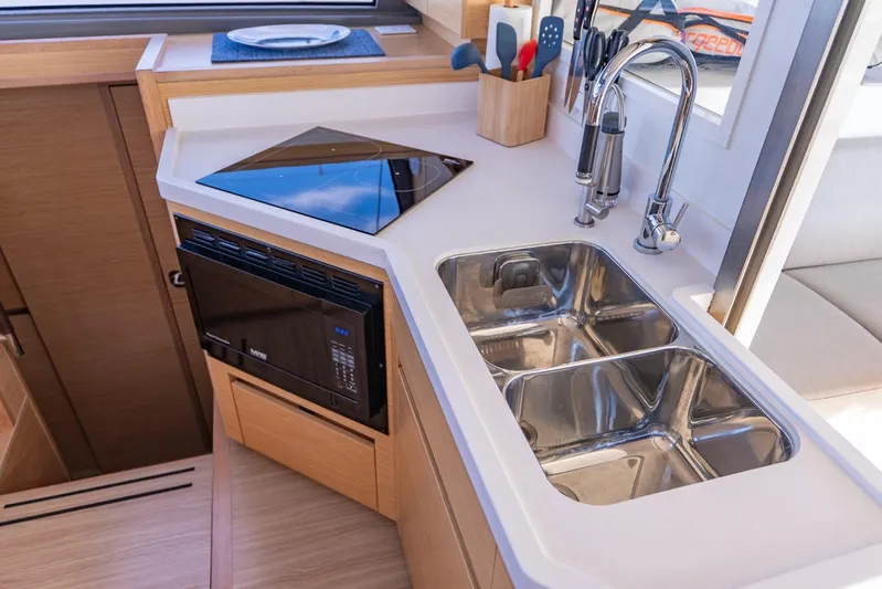 Nostos Yacht Photos Pics Modern kitchen area in a 2020 Nautitech 40 Open yacht, featuring a sink and appliances.