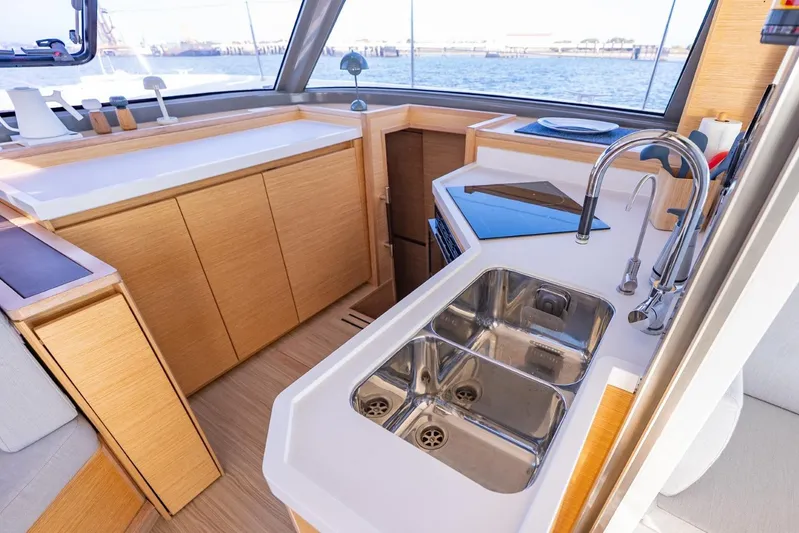 Nostos Yacht Photos Pics Modern kitchen area on a 2020 Nautitech 40 Open catamaran with dual sinks and sleek design.