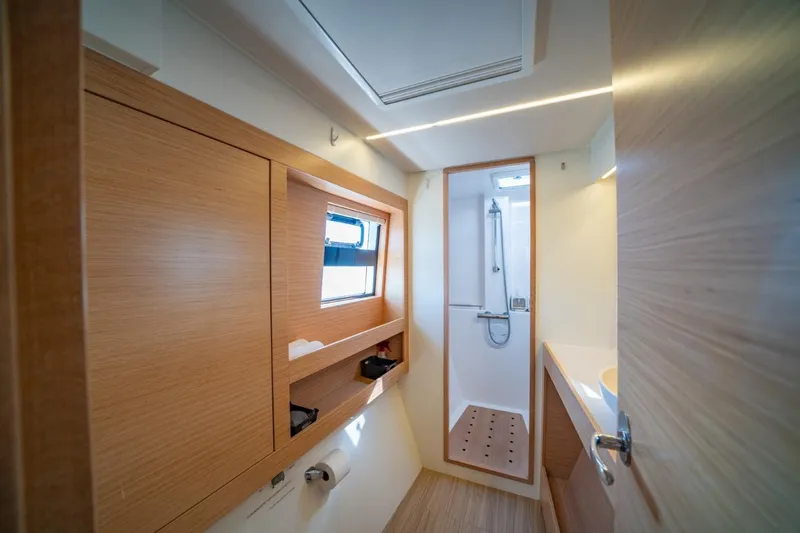 Nostos Yacht Photos Pics Modern bathroom interior of 2020 Nautitech 40 Open catamaran, featuring wood accents and shower.