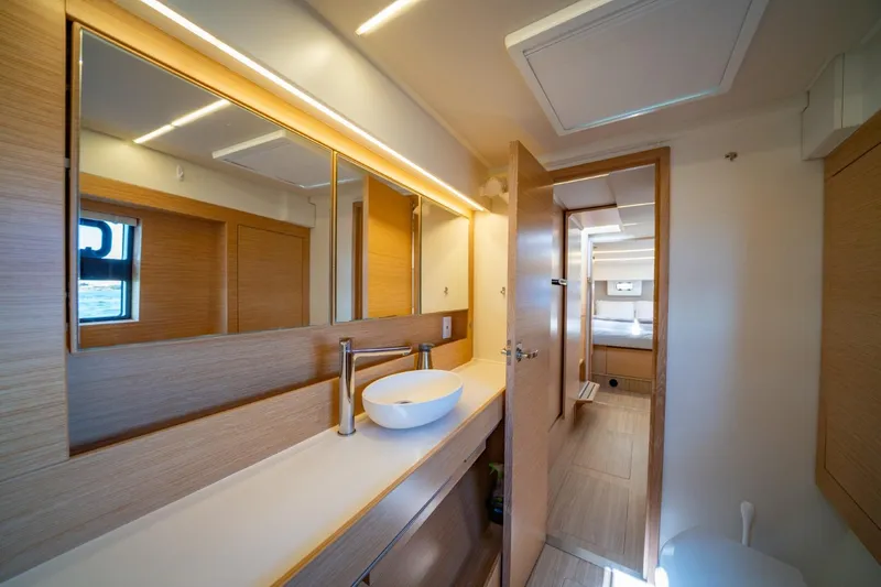 Nostos Yacht Photos Pics Modern bathroom interior of 2020 Nautitech 40 Open catamaran, featuring sleek design and wood accents.