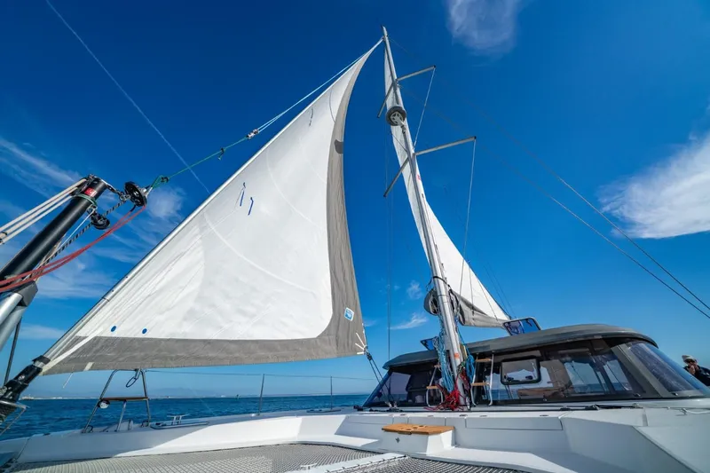 Nostos Yacht Photos Pics Sailing catamaran Nautitech 40 Open 2020 with sails up against clear blue sky.