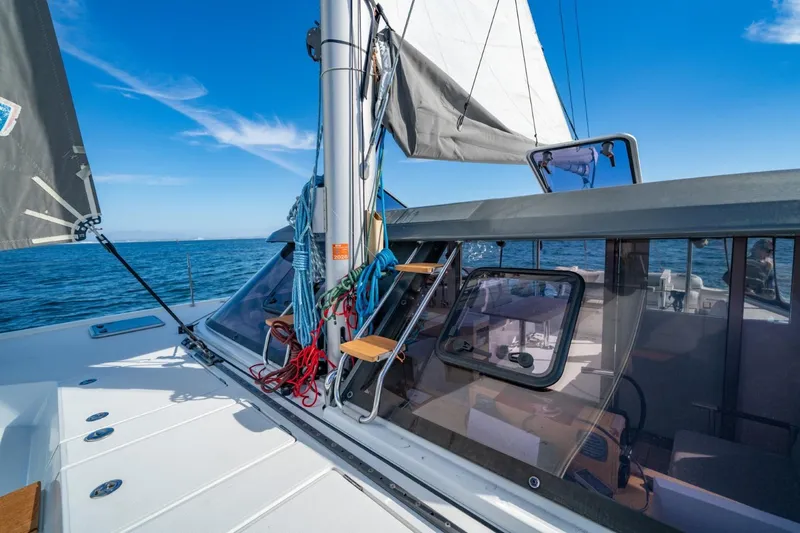 Nostos Yacht Photos Pics 2020 Nautitech 40 Open catamaran sailing on open sea under clear blue sky.