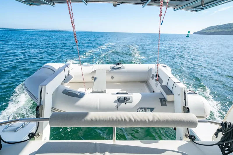 Nostos Yacht Photos Pics 2020 Nautitech 40 Open catamaran with inflatable dinghy on open sea.