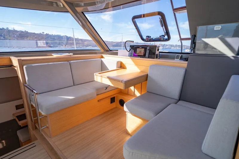 Nostos Yacht Photos Pics Modern interior of 2020 Nautitech 40 Open catamaran with comfortable seating and navigation equipment.