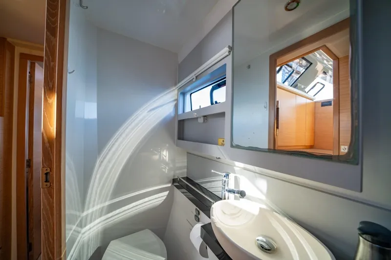 Nostos Yacht Photos Pics Modern bathroom interior of 2020 Nautitech 40 Open catamaran, featuring sleek design and natural light.
