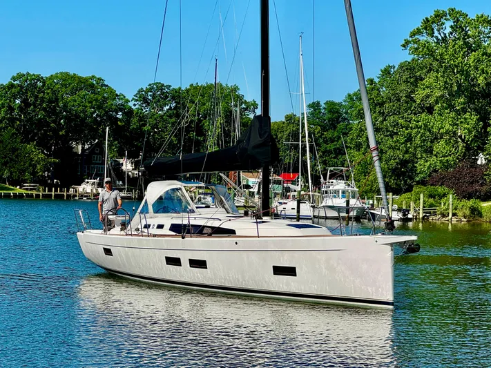  Yacht Photos Pics 2024 J Boats J/40 sailboat on calm water, surrounded by lush greenery.