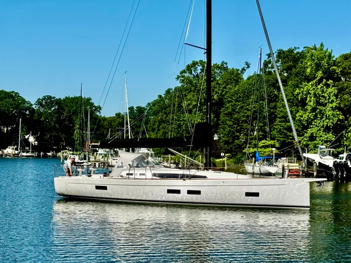  Yacht Photos Pics 2024 J Boats J/40 sailboat on a serene lake with lush green trees.