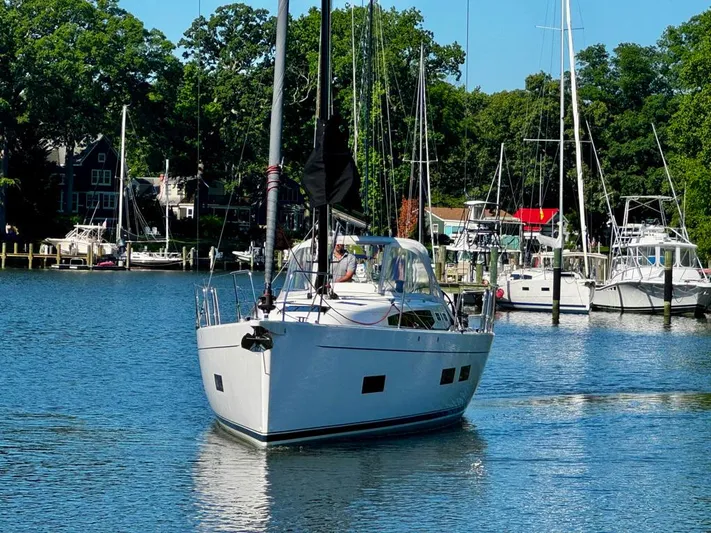  Yacht Photos Pics 2024 J Boats J/40 sailing in a serene marina with lush greenery.