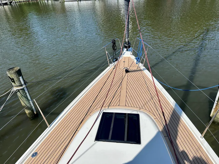  Yacht Photos Pics 2024 J Boats J/40 sailboat deck with teak finish, docked on calm water.