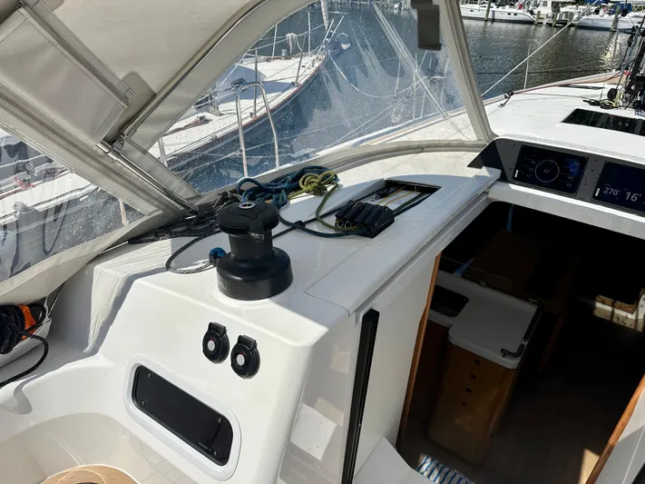  Yacht Photos Pics 2024 J Boats J/40 cockpit with winch, ropes, and navigation instruments in a marina setting.