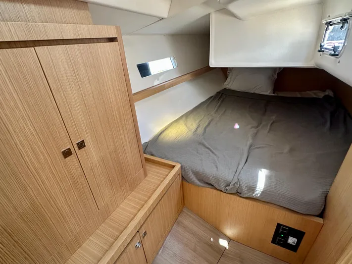  Yacht Photos Pics 2024 J Boats J/40 cabin interior with wooden cabinetry and cozy bed.