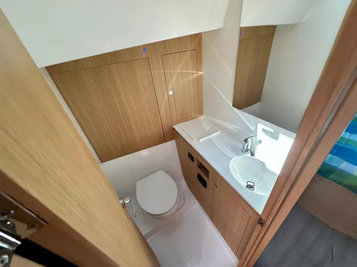 Yacht Photos Pics 2024 J Boats J/40 yacht bathroom with modern fixtures and wooden cabinetry.