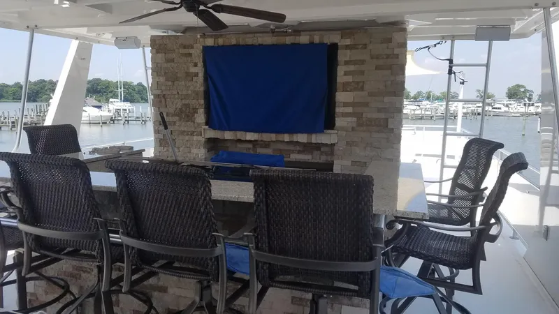 St. Somewhere Yacht Photos Pics Outdoor seating area on 2017 Sumerset houseboat with bar and covered TV.