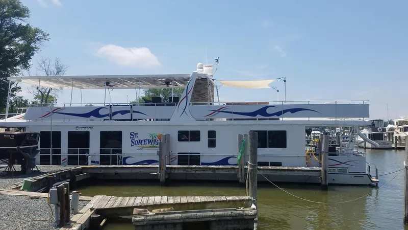 St. Somewhere Yacht Photos Pics 2017 Sumerset houseboat docked at a marina, featuring a spacious upper deck.