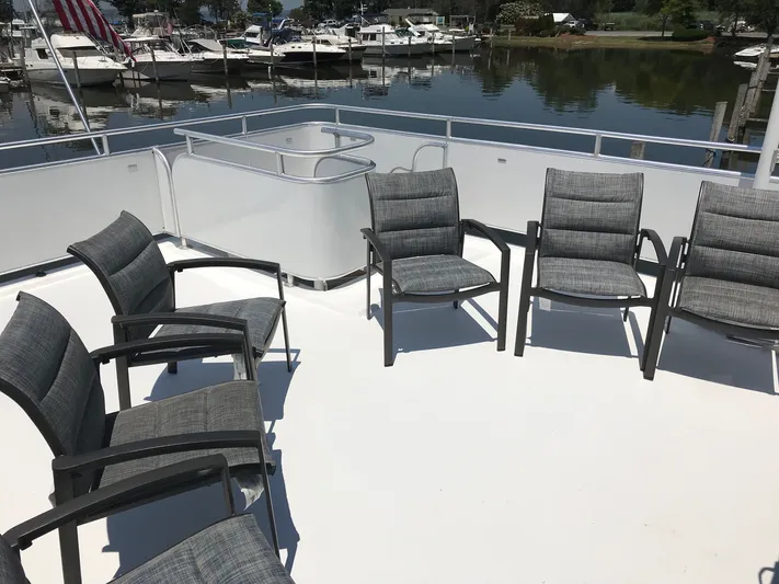 St. Somewhere Yacht Photos Pics Rooftop seating area on 2017 Sumerset houseboat with marina view.