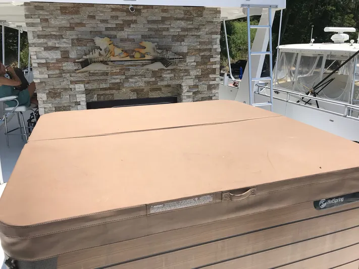 St. Somewhere Yacht Photos Pics 2017 Sumerset houseboat with hot tub and stone fireplace on deck.