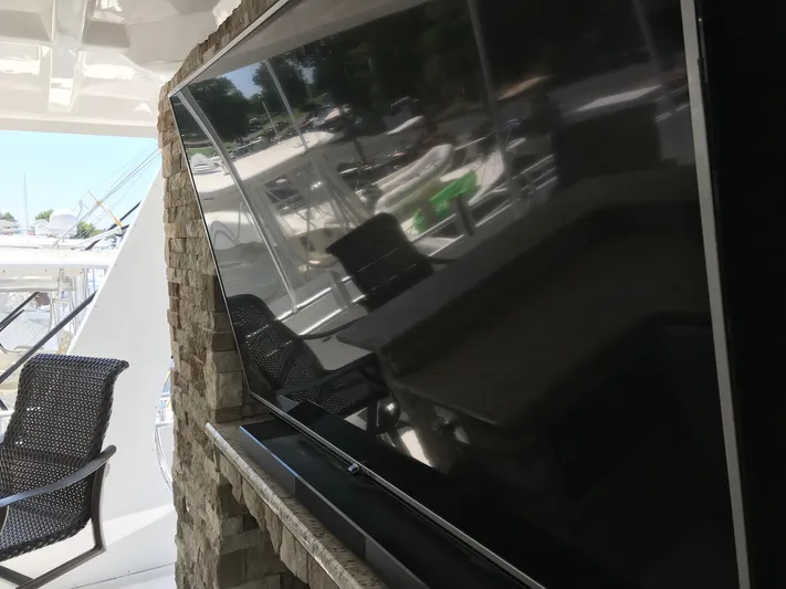 St. Somewhere Yacht Photos Pics Outdoor seating area on a 2017 Sumerset houseboat with a mounted TV.