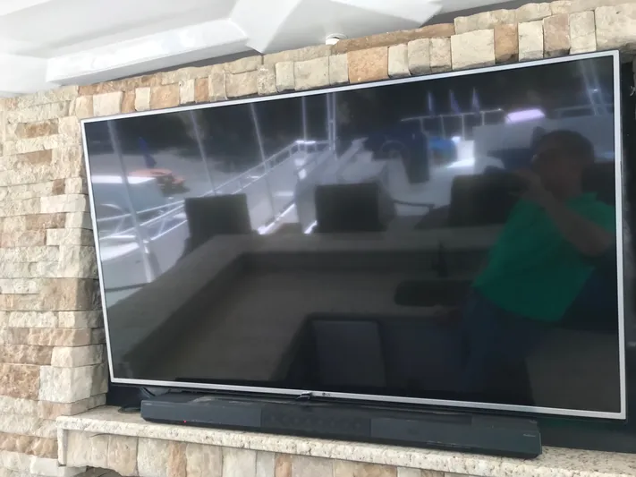 St. Somewhere Yacht Photos Pics Flat-screen TV on Sumerset 2017 houseboat with stone wall backdrop.