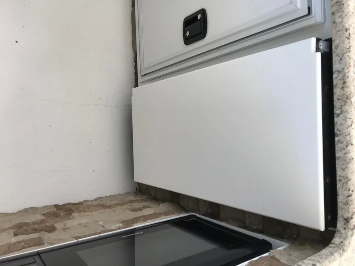 St. Somewhere Yacht Photos Pics 2017 Sumerset Houseboat storage compartment with white panel and handle.