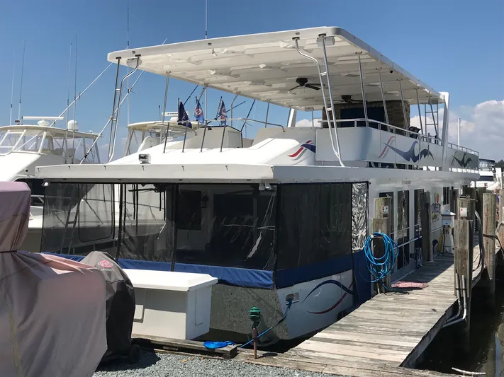 St. Somewhere Yacht Photos Pics 2017 Sumerset houseboat docked, featuring upper deck and covered lower area.