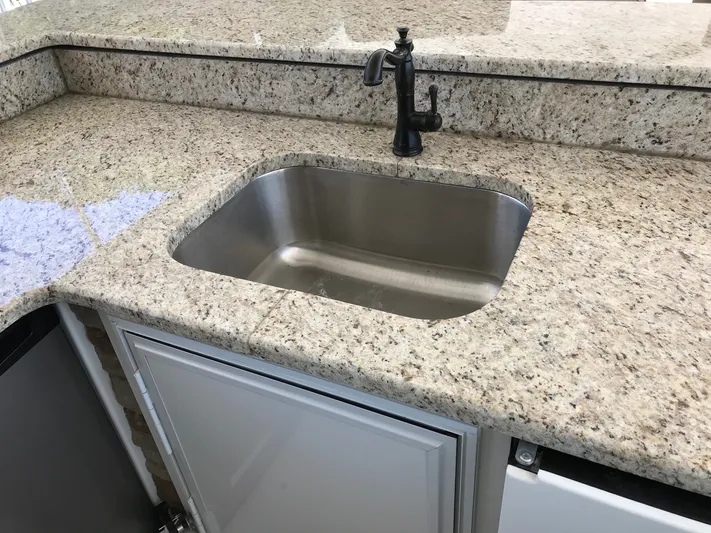 St. Somewhere Yacht Photos Pics Granite countertop with stainless steel sink on 2017 Sumerset houseboat kitchen.