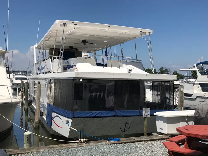 St. Somewhere Yacht Photos Pics 2017 Sumerset houseboat docked, featuring upper deck and covered lower area.