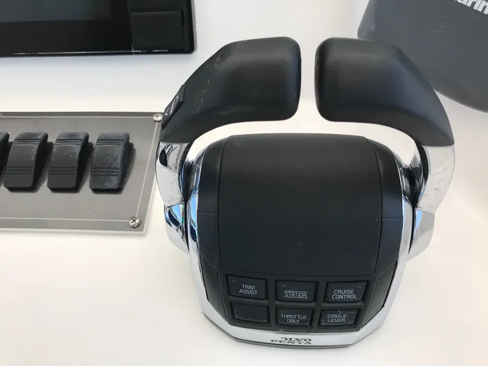 St. Somewhere Yacht Photos Pics Control panel of a 2017 Sumerset houseboat with throttle and cruise control buttons.