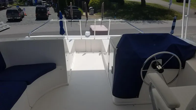 St. Somewhere Yacht Photos Pics 2017 Sumerset houseboat deck with steering wheel and seating area.