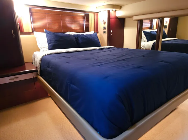  Yacht Photos Pics Luxurious bedroom interior of 2006 Sea Ray 580 Sedan Bridge yacht with blue bedding.
