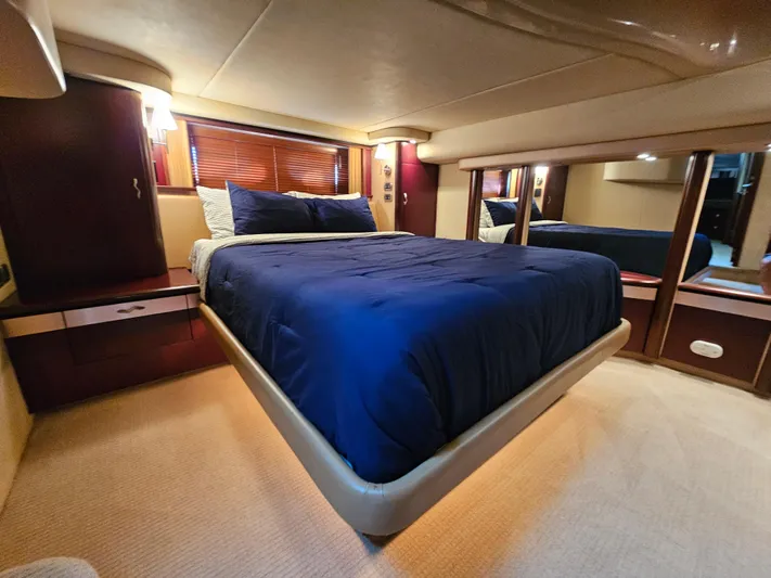  Yacht Photos Pics Luxurious bedroom interior of 2006 Sea Ray 580 Sedan Bridge yacht with blue bedding.