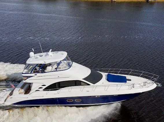  Yacht Photos Pics 2006 Sea Ray 580 Sedan Bridge yacht cruising on open water.