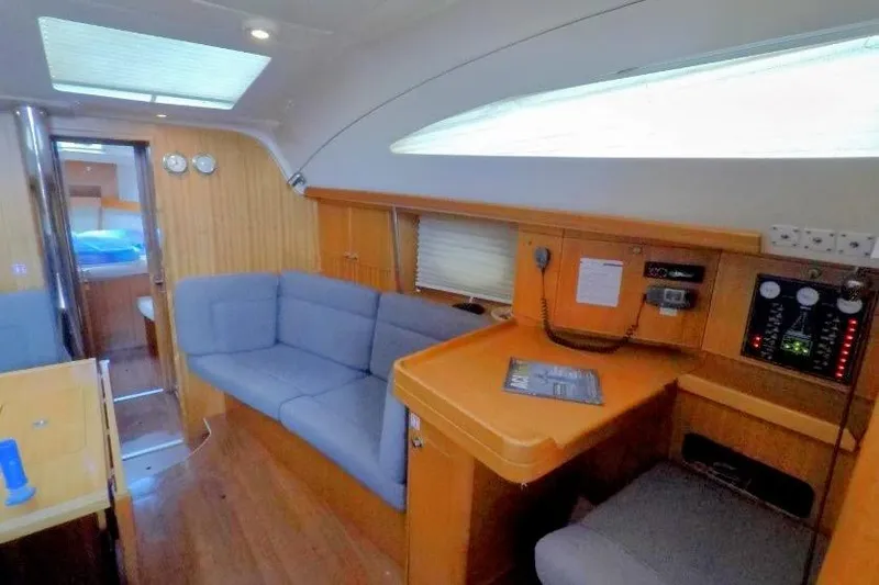 Aventura Yacht Photos Pics Interior of 2008 Elan Impression yacht with cozy seating and navigation area.