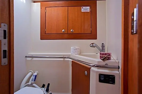 Aventura Yacht Photos Pics 2008 Elan Impression yacht bathroom with wooden cabinets and modern fixtures.