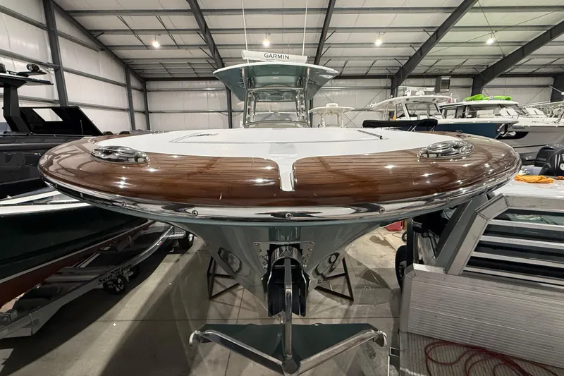  Yacht Photos Pics 2021 Mag Bay 33 CC boat in showroom, featuring sleek design and polished wood accents.