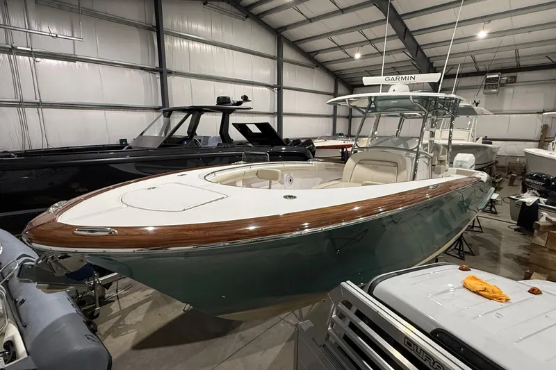  Yacht Photos Pics 2021 Mag Bay 33 CC boat in a storage facility, featuring sleek design and modern equipment.